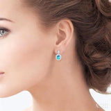7X5 MM Oval Cut Blue Topaz and 1/20 ctw Round Cut Diamond Semi Precious Earring in Sterling Silver